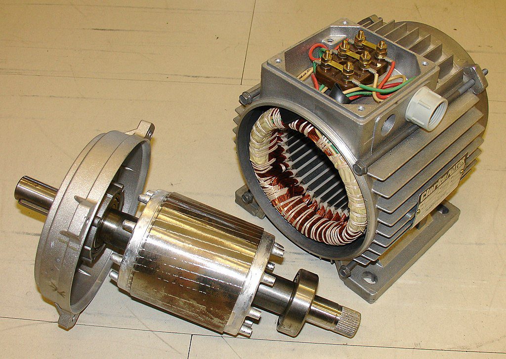 An electric motor opened up showing the rotor (left) and the stator (right)