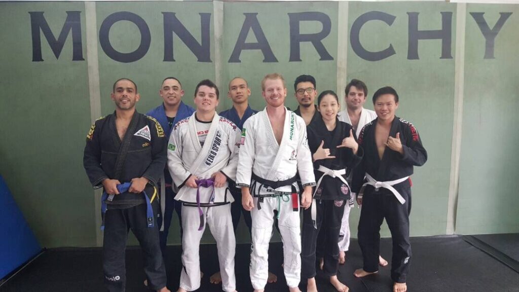 andrew in white teaching brazilian jiu-jitsu