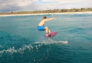 A surfer using Cloud 9 surf foils on a lake