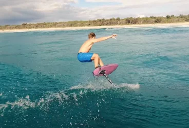 A surfer using Cloud 9 surf foils on a lake